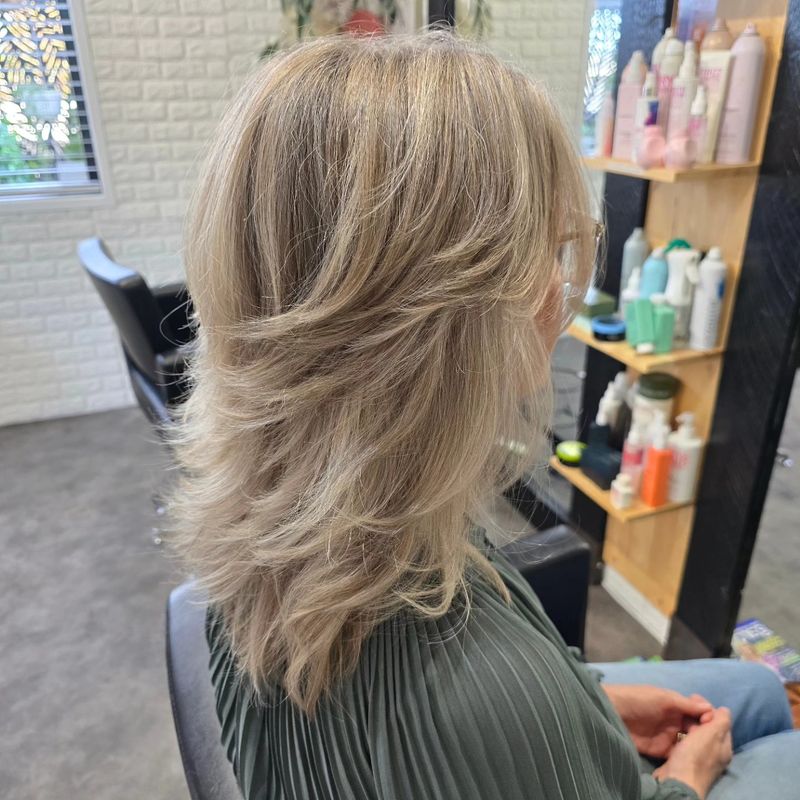 Blonde layered cut and blowout at Studio 15 boutique salon Northland