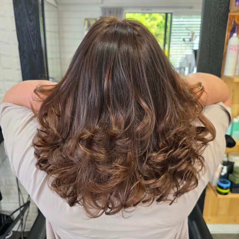 Brunette curls blowout styling at Studio 15 boutique salon Northland