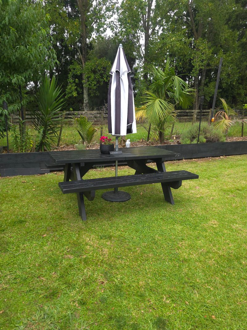 Outdoor seating area with garden views at Studio 15 boutique salon Waipapa Northland